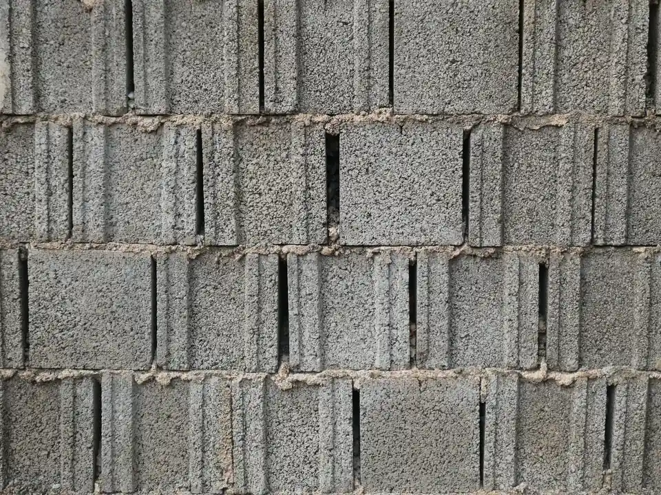 A wall of grey sandcrete blocks