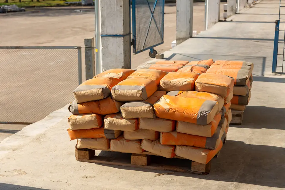 Bagged cement stacked on pallets on a building site